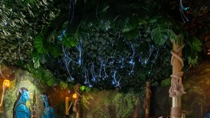 A circular bed with a wooden frame and a ladder, surrounded by a forest-themed mural and string lights. - Mickey's Mansion Luxury Themed Pool Home, Arcade, Theater (Four Corners)
