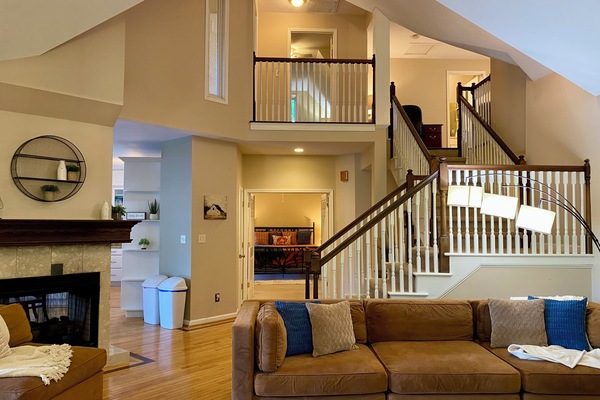 Open main level LR with vaulted ceiling, double-sided fireplace.