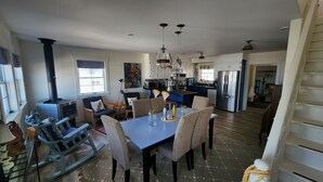 A spacious kitchen with a dining area, a built-in stove, and modern appliances.