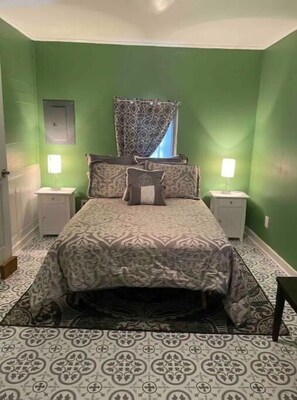 Relax in this serene bedroom with a comfortable bed, bedside tables, and lamps.