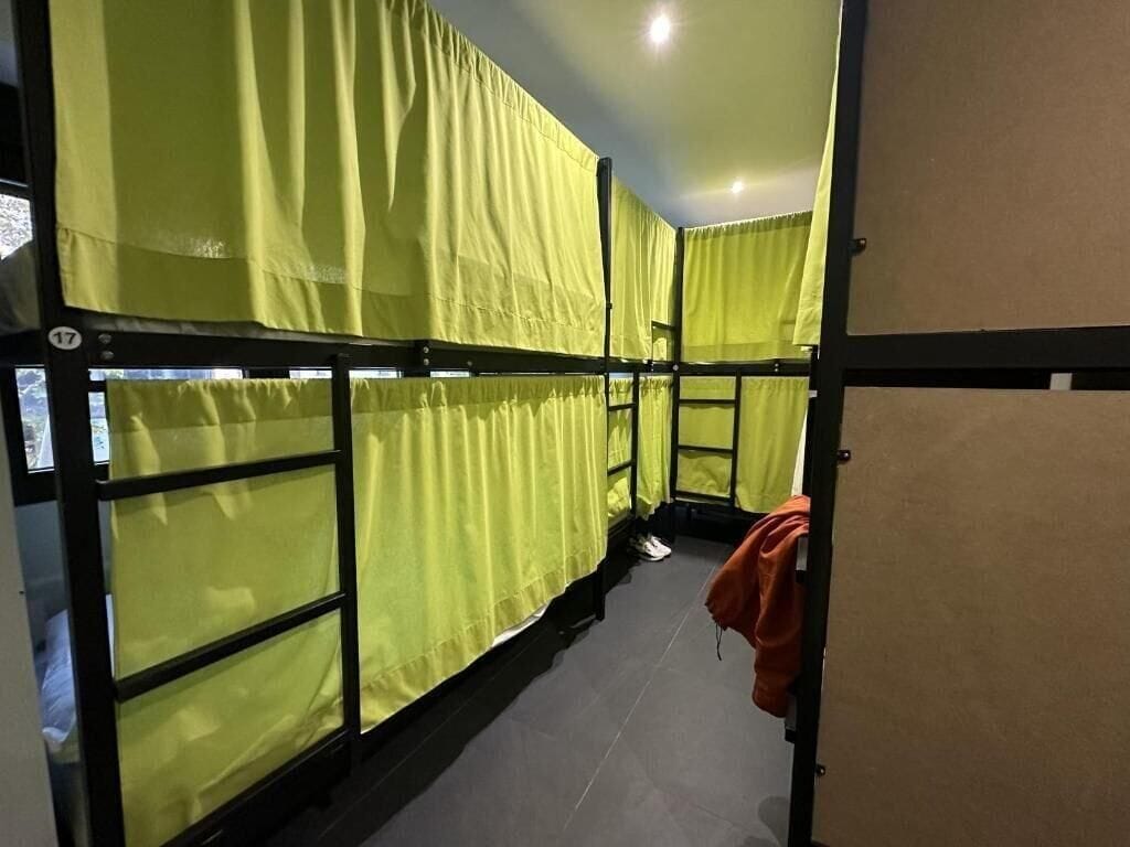 A room with bunk beds, a door, and a wall with a number.