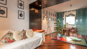 A modern living room with a sofa, coffee table, and artwork on the walls. - Tiffany's Apartment Flaminio (Roma)