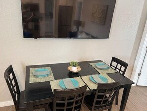 Enjoy meals in this dining area with a table for four, a flat-screen TV, and comfortable seating.