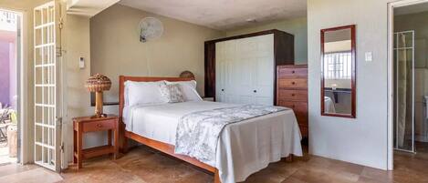 Un dormitorio con cama, mesita de noche y armario.