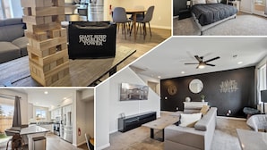 A modern apartment with a kitchen, dining area, and living room. It includes a jenga tower, a black bag, and a ceiling fan.