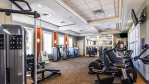 A gym with various exercise equipment, including treadmills, weight machines, and free weights. - 6BR Villa Oasis: Private Pool & Spa - Solterra Retreat (Davenport)