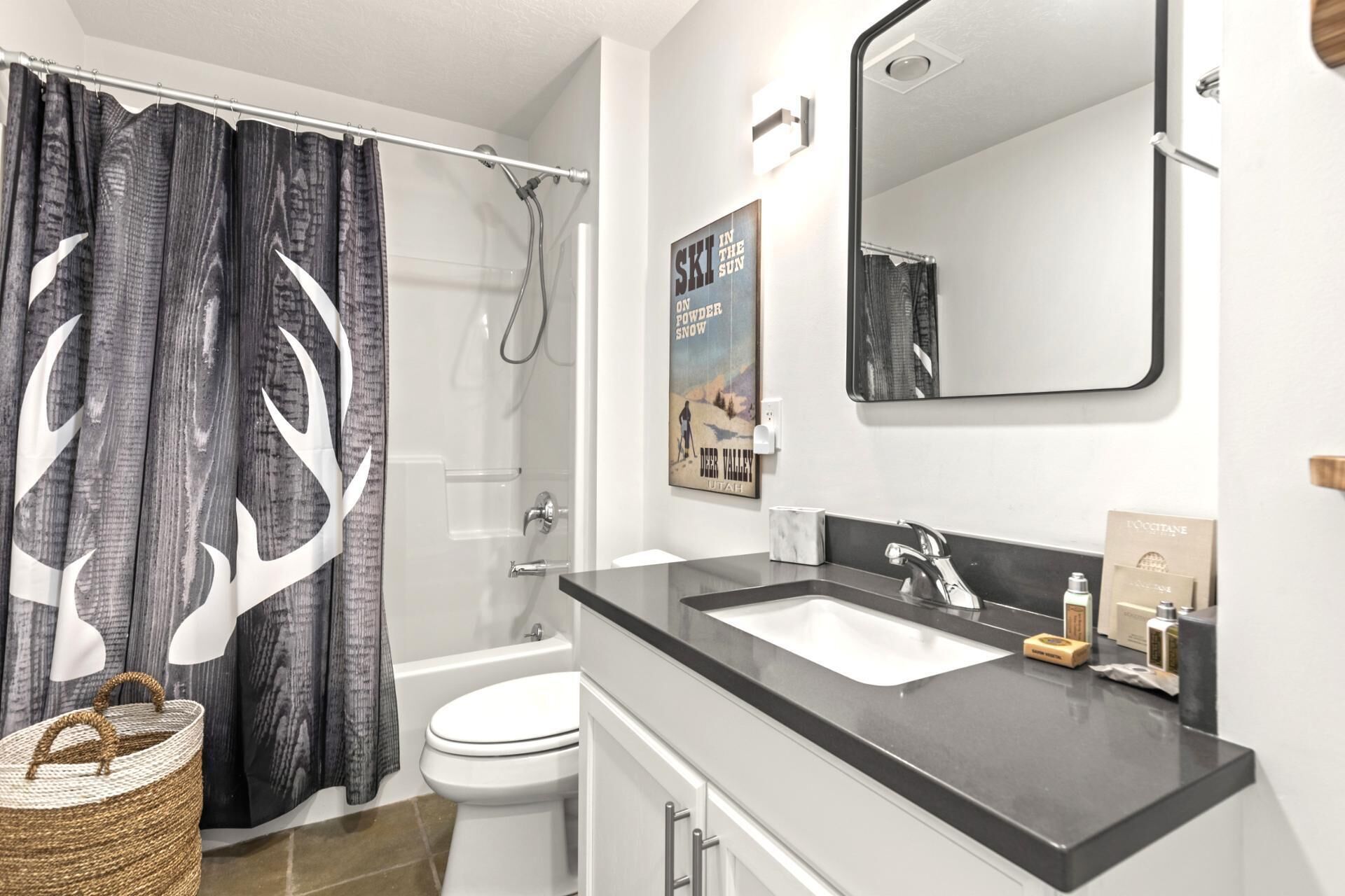 A bathroom with a shower, toilet, and sink.