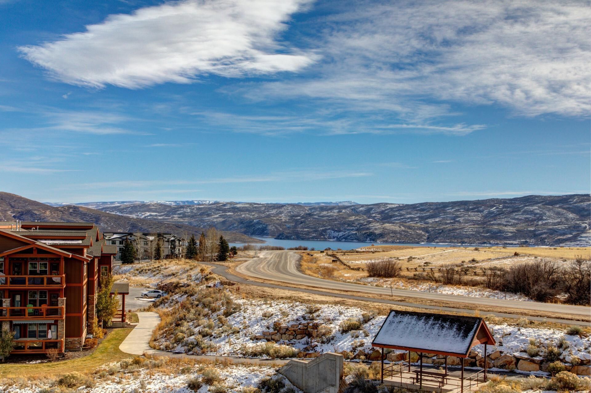 A lodge with a view of a lake and mountains.