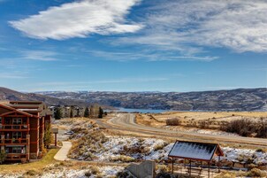 A lodge with a view of a lake and mountains.