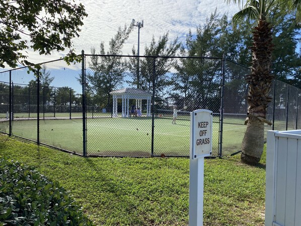A fenced tennis court with a gazebo in the background. - Bimini Bay, Bahamas, Good Vibes Condo 2BR/2 Sleep6 (Bimini)