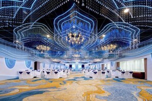 A spacious hall with a patterned floor, a chandelier, and tables set for a formal event. - Riverside Hotel (Taizhou)