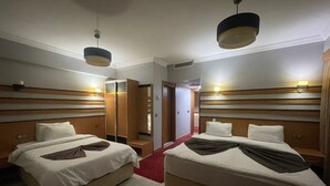 A hotel room with two beds, a red carpet, wooden headboards, and a mirror. - Quars Garden Hotel (Düzce)