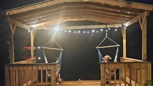 A wooden gazebo with a covered deck, string lights, and two hammocks. - Beautiful and peaceful Lake house (Inverness)