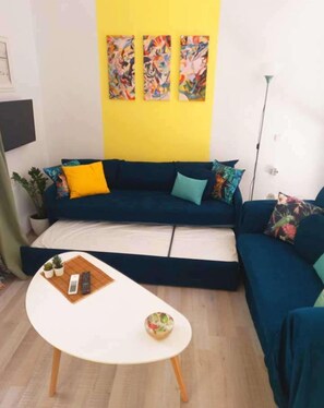 A living room with a sofa set, a coffee table, and a floor lamp. - Pirgos Colorful Studio, Sleeps 2, Parking WiFi Ac (Pirgos Monofatsiou Heraklion)