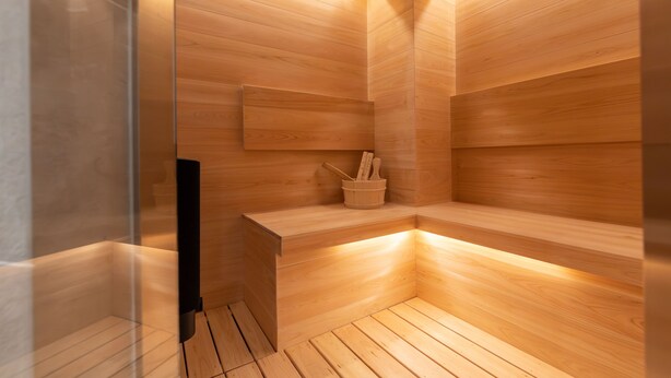A sauna with wooden walls and a bench. - ONE WORLD Sakaisuji Hommachi (Osaka)