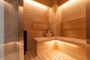 A sauna with wooden walls and a bench. - ONE WORLD Sakaisuji Hommachi (Osaka)