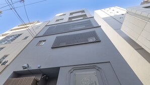 A modern building with a prominent entrance and a sign reading "ONE WORLD". - ONE WORLD Sakaisuji Hommachi (Osaka)