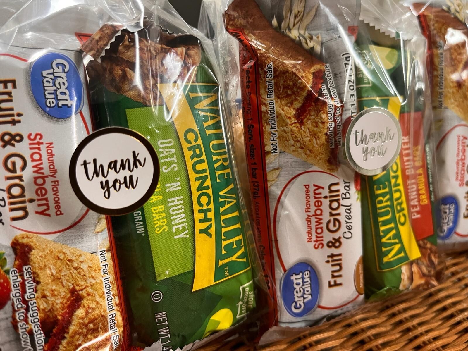 A variety of packaged food items, including snacks and cereals, with labels indicating flavors like strawberry and honey.