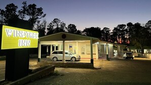 A Wind Tree Inn with a covered parking area and a signboard.