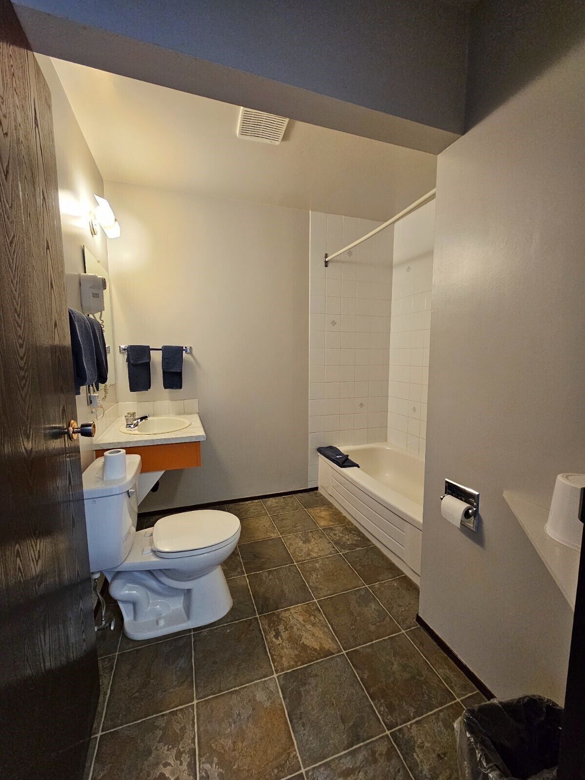A bathroom with a toilet, sink, and bathtub.