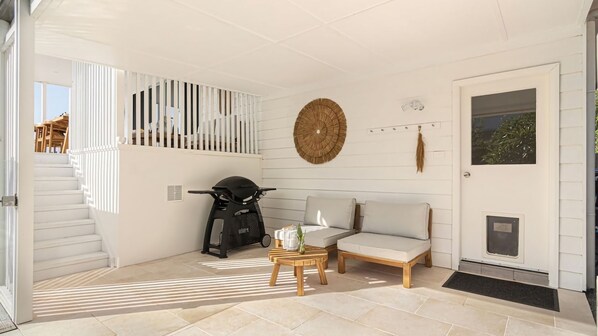 A modern interior with a staircase, a sofa, a coffee table, and a scooter.