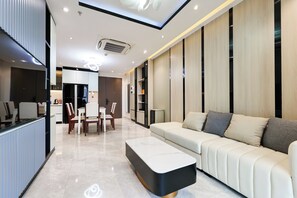 Deluxe Apartment | Living area | 55-inch Smart TV with cable channels, TV, pay movies - Midtown by Saigon (Ho Chi Minh City)