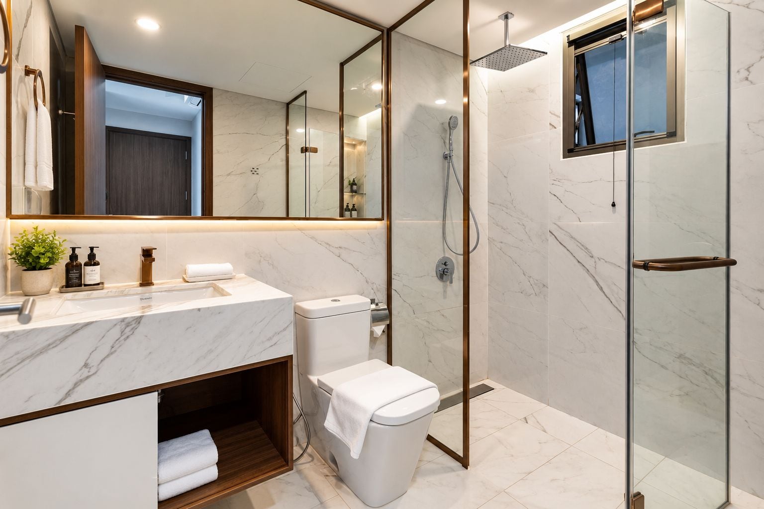 A modern bathroom with a marble countertop, a glass shower enclosure, and a wooden vanity.