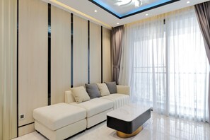 Deluxe Apartment | Living area | 55-inch Smart TV with cable channels, TV, pay movies - Midtown by Saigon (Ho Chi Minh City)