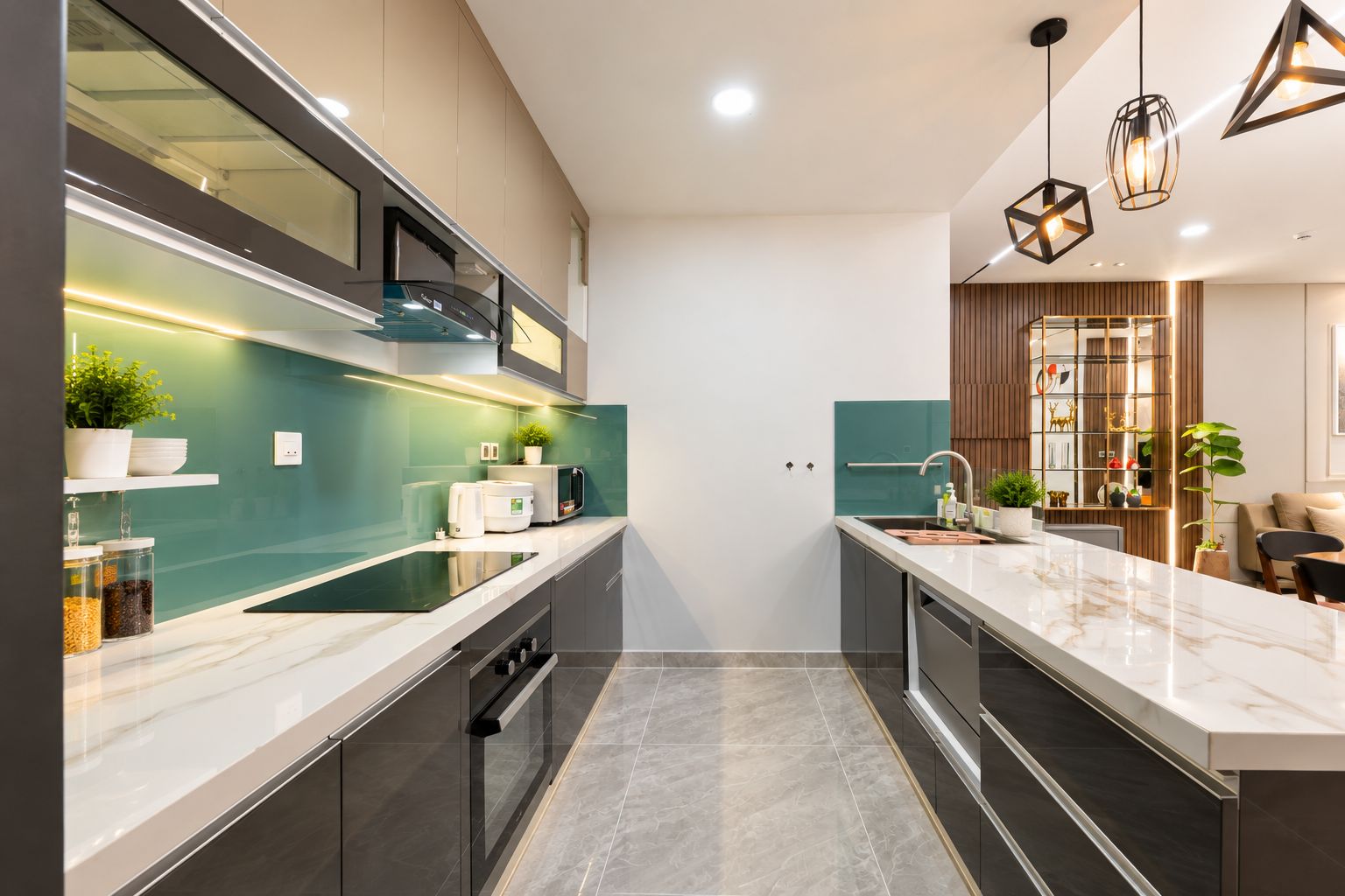 A modern kitchen with a central island, built-in appliances, and pendant lighting.