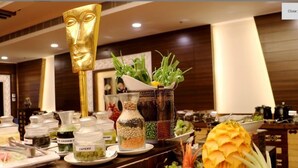 A buffet setup with various food items and condiments. - Tiaraa Hotels & Resorts (Ramnagar)