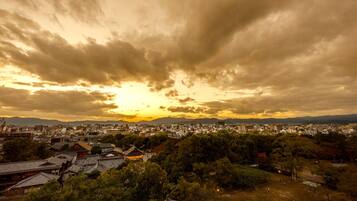 A cityscape with traditional architecture and a sunset.