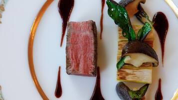 A plate with a dish featuring meat, vegetables, and sauce.