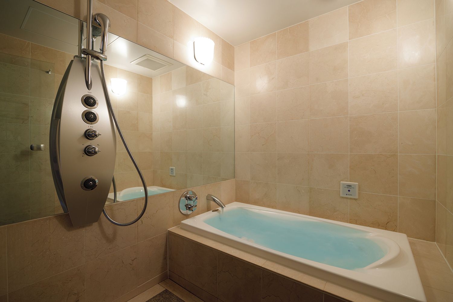 A bathroom with a bathtub, a shower, and a mirror.