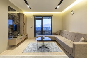 Family Suite | Living area | 80-inch LCD TV with satellite channels, TV