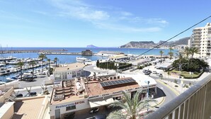 A coastal view with a marina, a restaurant named 'Restaurante BAYDAL', and a high-rise building with balconies. - A84 CALPE TOWER 3-10 (Calpe)