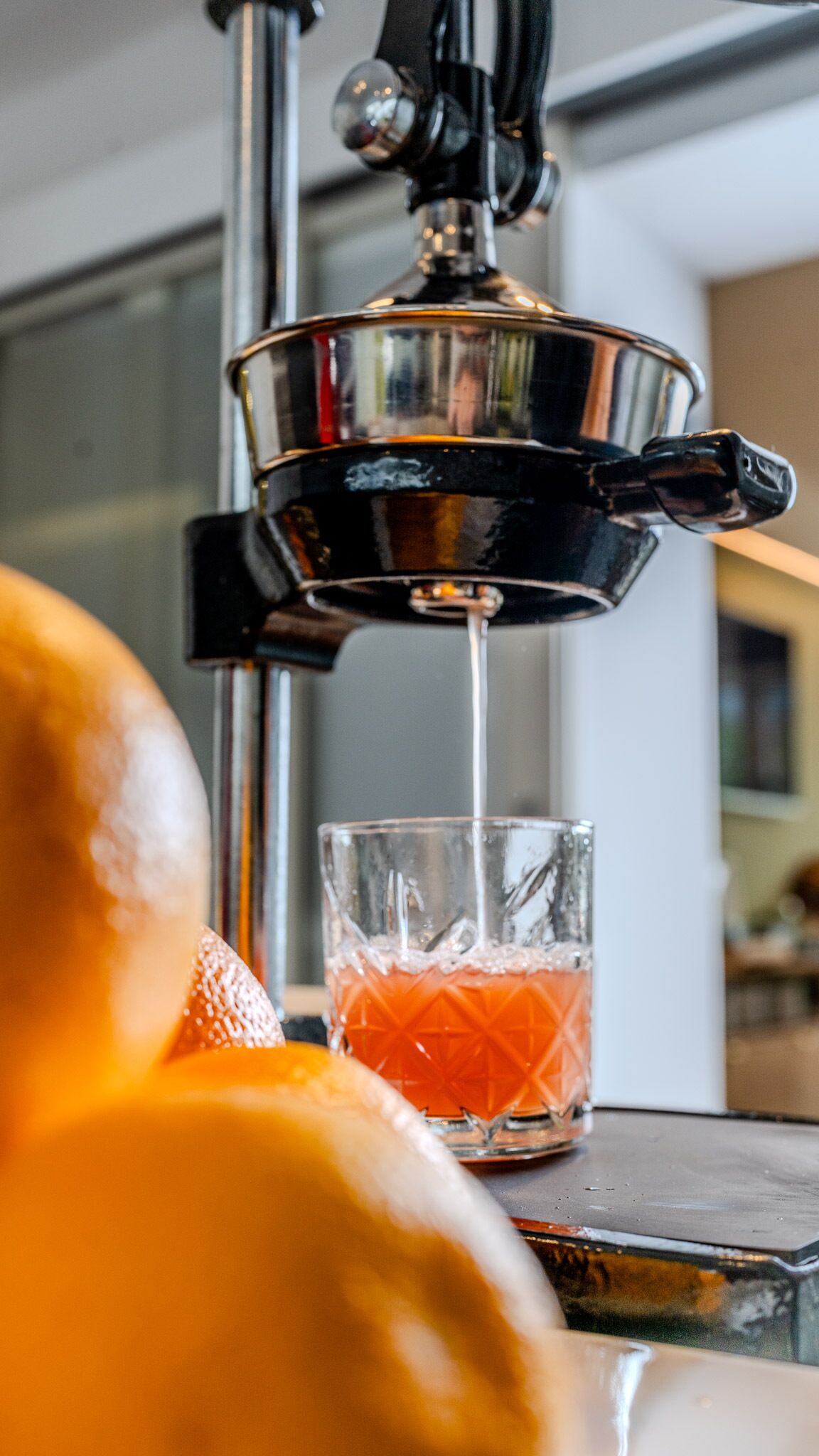 A beverage dispenser pouring a drink into a glass.