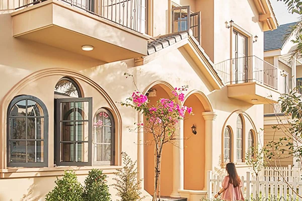 A two-story building with arched windows and a balcony.