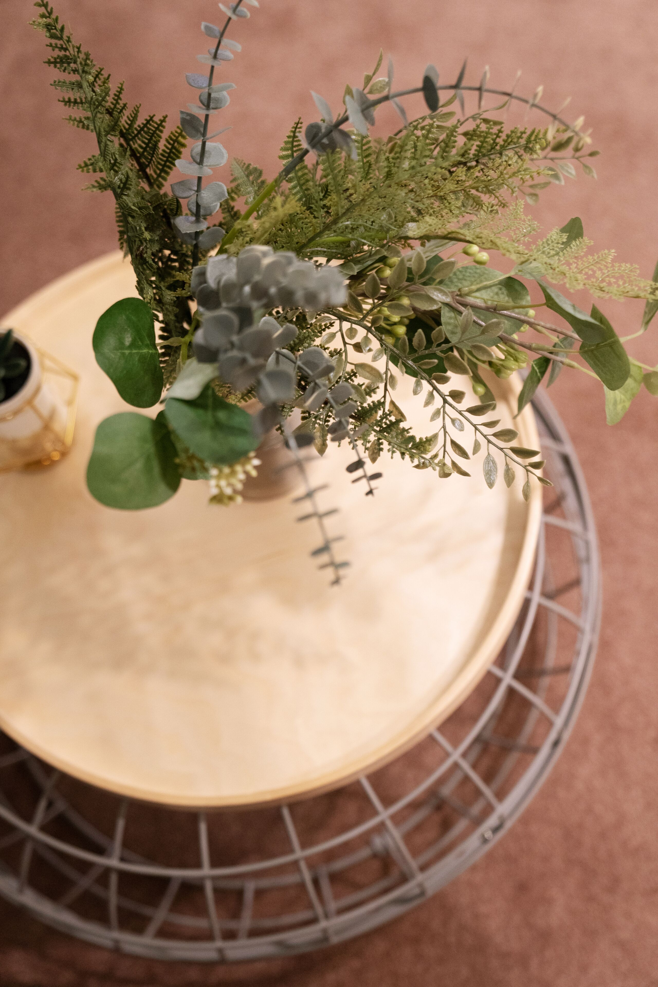 A round table with a potted plant arrangement.
