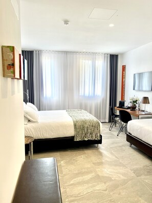A hotel room with two beds, a desk, a chair, a TV, and a large window with curtains. - Le Muraine  (Bergamo)