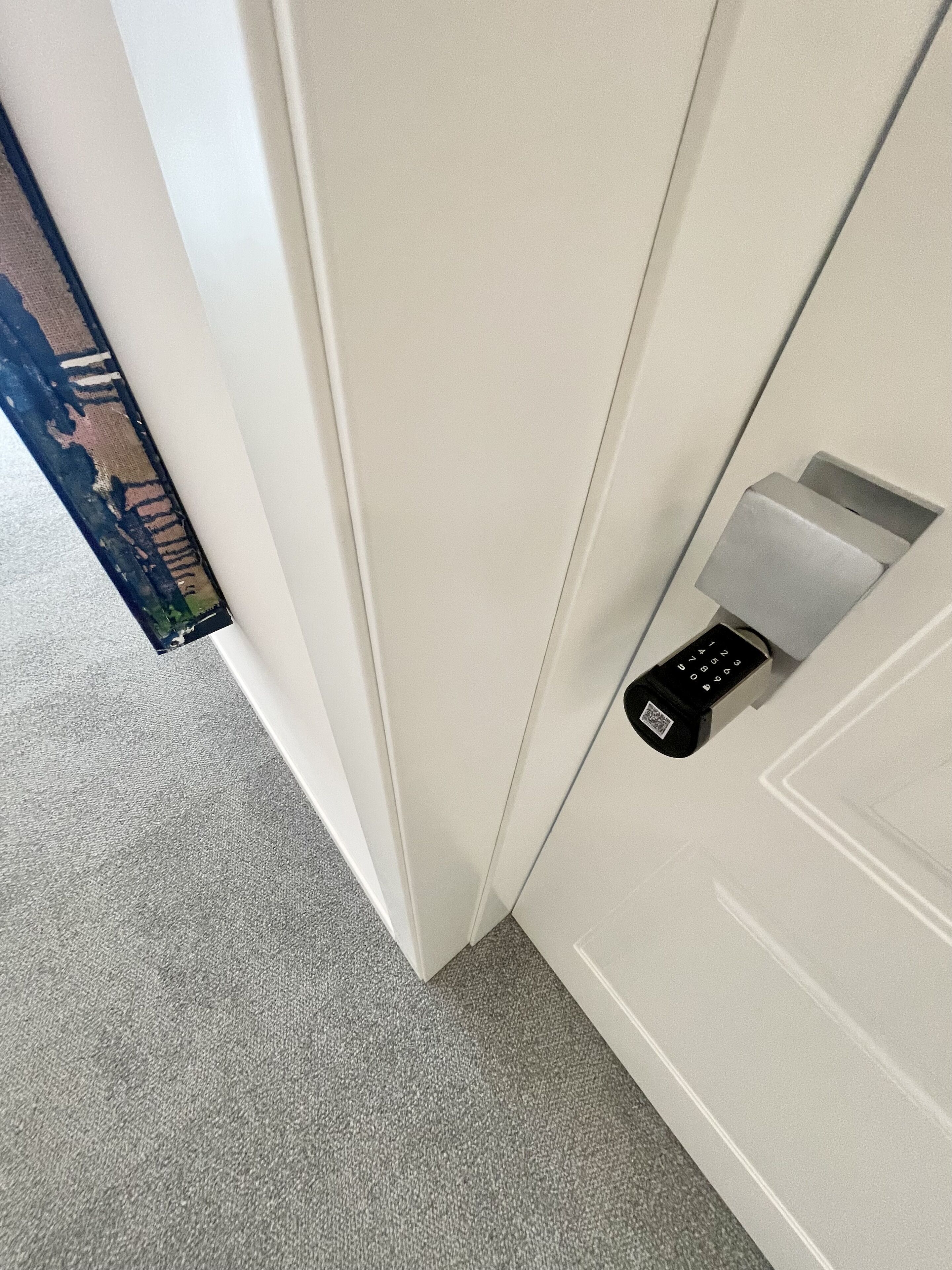 A door with a keypad lock and a card reader.