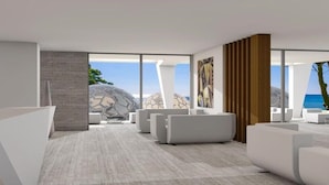 A modern interior with large windows, white furniture, and a view of the sea. - Eco Dome Crete (Agios Nikolaos)