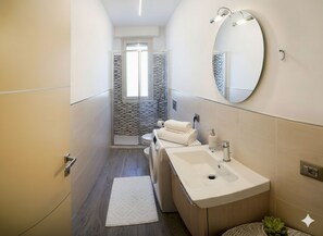 Un baño moderno con ducha, inodoro y lavabo.