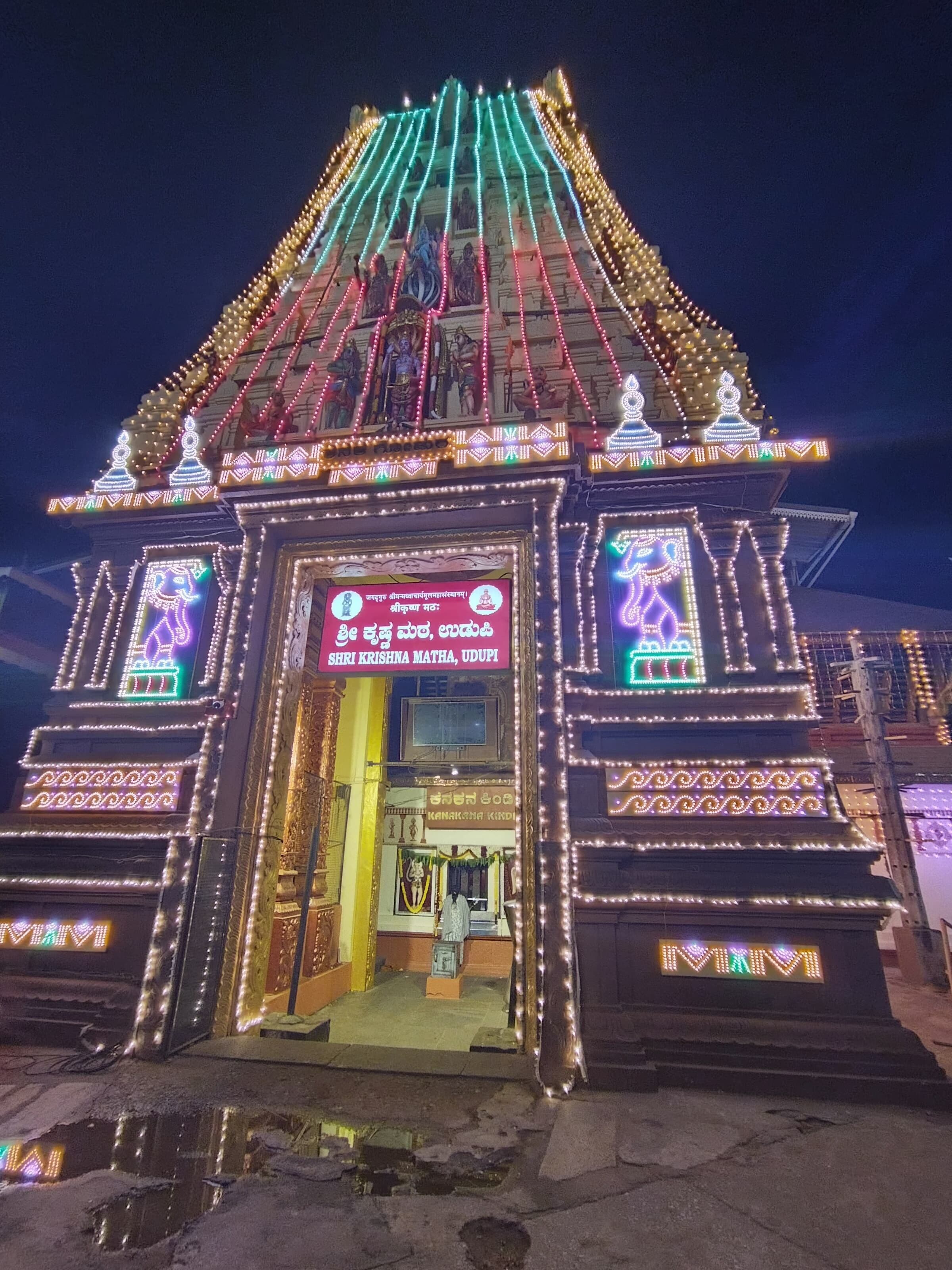 A temple with intricate carvings and colorful lights.