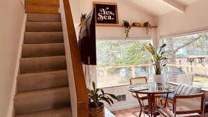 A staircase leading to a dining area with a view of the outdoors. - The Weekender | Hot Tub| Neskowin Village (Neskowin)