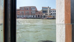 A view of Venice's Grand Canal with historic buildings and gondolas. - Palace Canal View by Wonderful Italy (Venice)