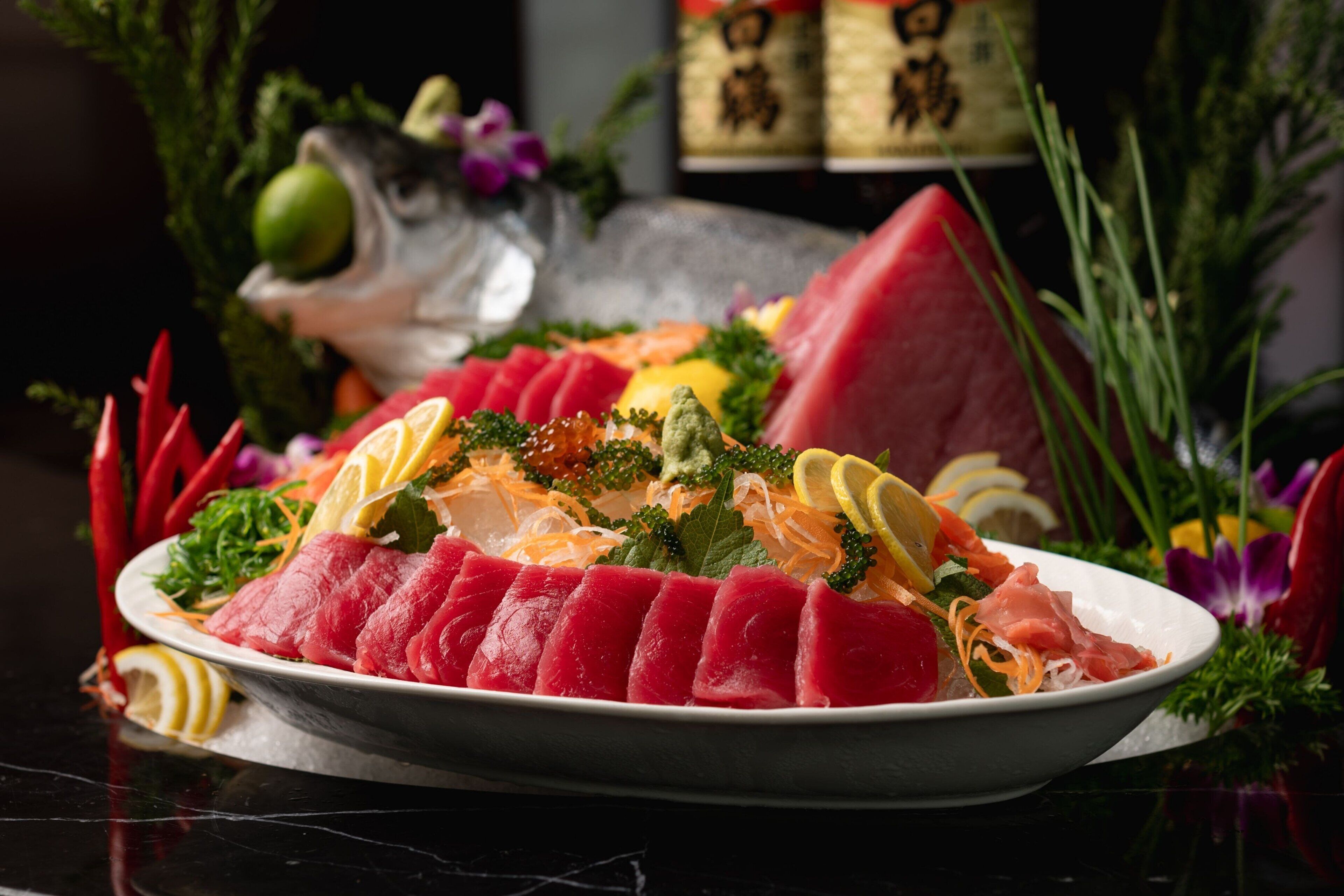 A plate of sushi with various types of fish and garnishes.