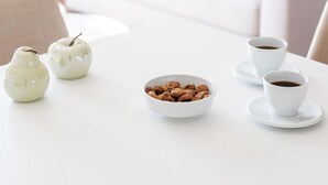 A white dining table with a bowl of cookies and two white cups of coffee. - Superior Apartment (Thasos)