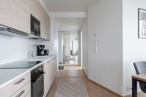 Exclusive Apartment | Living area | 40-inch flat-screen TV with cable channels, TV, heated floors