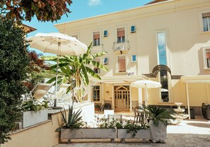 A courtyard with outdoor seating, planters, and a fountain.