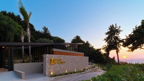 A modern building with a stone facade and a sign reading "CASA PALMERAS". - Casa Palmera, Casa Palmera (Rhodes)